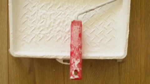 Dipping the paint roller into the white paint. Clip. Rolling paint. 動画素材 140135487