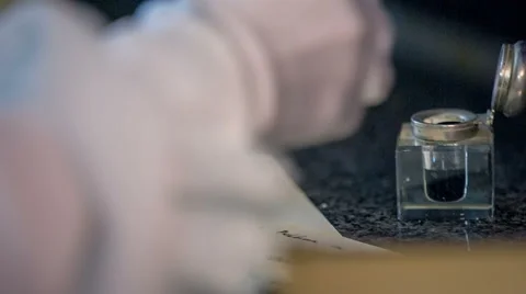 Dipping the pan in to the ink and continue Stock Footage 49425503