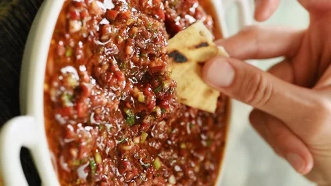 Dipping a piece of bread into freshly prepared Ezme. Vertical video. Vidéo 333708340