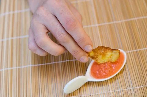 Dipping in sauce Stock Photos