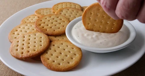 Dipping a snack cracker into a bowl of ranch dressing Stock Footage 89804082