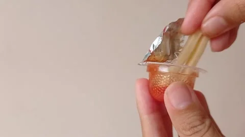 Dipping the snack into a small jar of tomato sauce Stock Footage 150215060