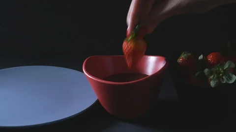 Dipping strawberry into chocolate mixture Stock Footage 106398856