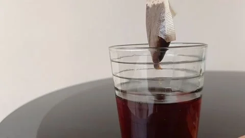 Dipping a teabag into a cup of tea Stock Footage 145621583