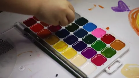Dips cotton wool in the aqualera palette of paints Stock Footage 170645064