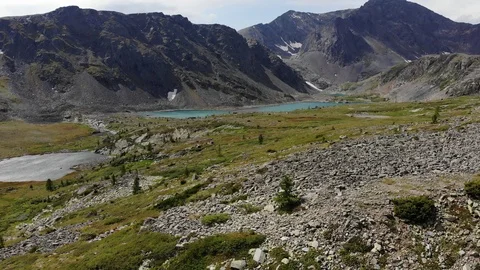 Direct aerial flight under emerald mountain lake. Altai. Stock Footage 103371959