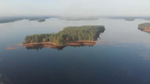 Direct aerial fliyng above small islands with pine forest. Karelia lake 動画素材 146319853
