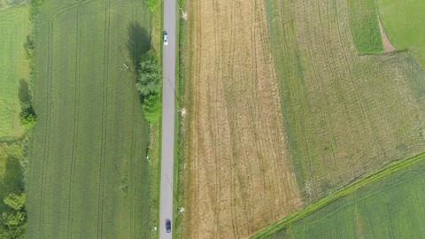 Direct overhead aerial view of a single car driving on a straight country road Stock Footage 324520476