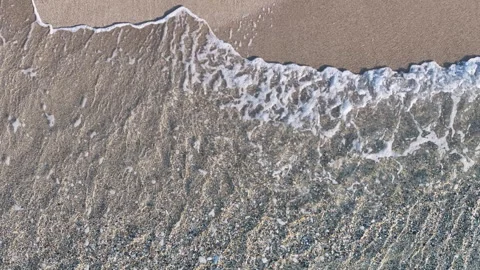 Direct overhead drone shot of wave meeting sand Stock Footage 263930014