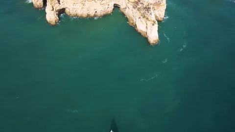 Direct overhead drone shot of white sailboat on deep turquoise Atlantic waters Stock Footage 330924478