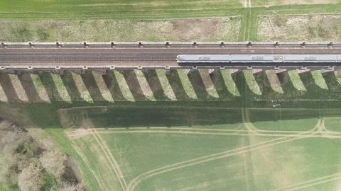 Direct overhead shot of passing train on viaduct bridge Video stock 124702198