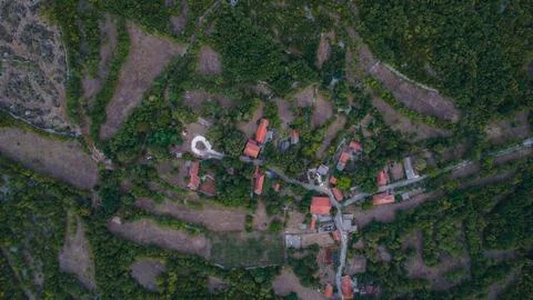 Direct top-down aerial view of a remote, dense rural village and its red houses Stock Photos