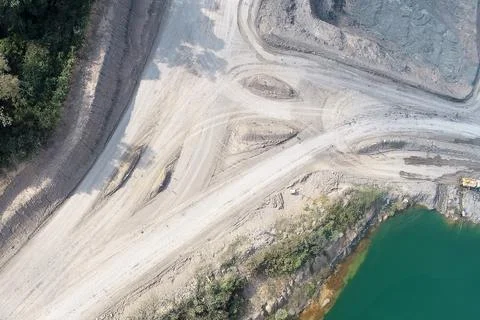 Direct top-down aerial view of a complex mining road intersection, unpaved .. Stock Photos