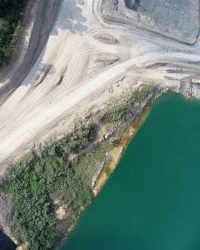 Direct top-down aerial view of an open pit mining site featuring unpaved ha.. Stock Photos