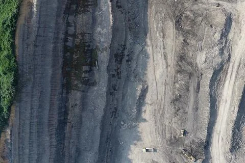 Direct top-down aerial view of an open-pit mining strip featuring vertical .. Stock Photos