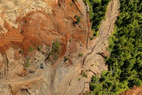 Direct top-down aerial view of a barren land boundary featuring winding veh.. Stock Photos