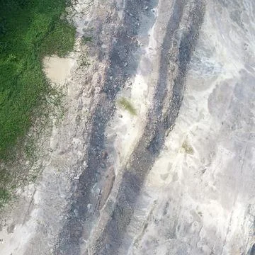 Direct top-down vertical aerial view of an open-pit excavation site showing.. Stock Photos