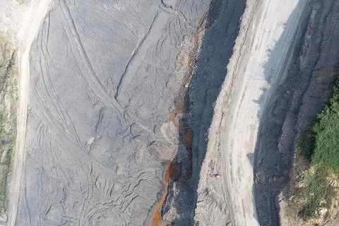 Direct top-down vertical aerial view of an open-pit mining bench showing an.. Stock Photos
