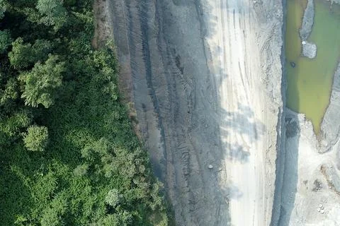 Direct top-down vertical aerial view of a mining perimeter, featuring a tra.. Stock Photos