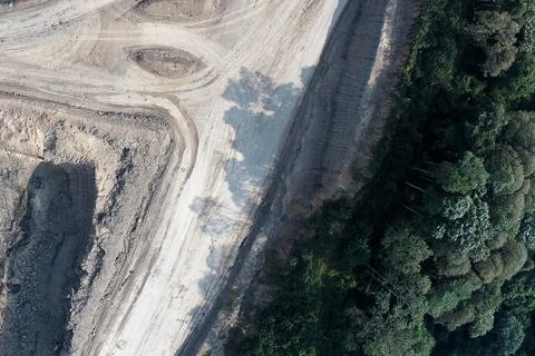 Direct top-down vertical aerial view of an industrial mining road boundary .. Stock Photos