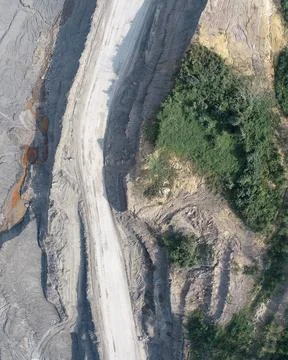 Direct top-down vertical aerial view of an industrial mining haul road runn.. Stock Photos