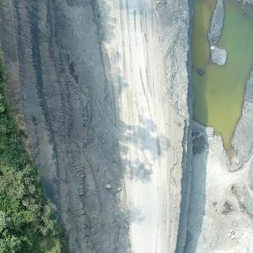 Direct top-down vertical aerial view of an open-pit mining site layout, fea.. Stock Photos