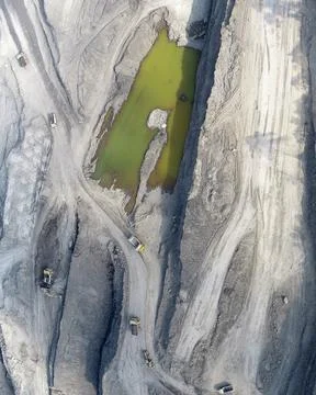 Direct top-down vertical aerial view of an expansive open-pit mining layout.. Stock Photos