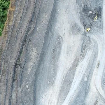 Direct top-down vertical aerial view of an open-pit mining operation showin.. Stock Photos