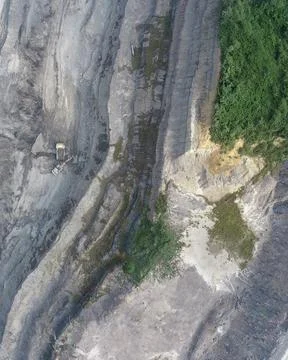 Direct top-down vertical aerial view of an open-pit mining site showing an .. Stock Photos