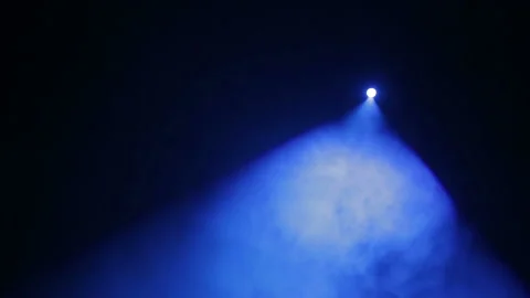 Directing a beam of light from a profile projector to the stage in the smoke Stock Footage 97295843