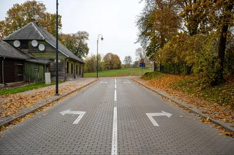 Direction arrows on paved road at intersection, choice concept Stock Photos
