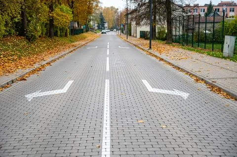 Direction arrows on paved road at intersection, choice concept Stock Photos