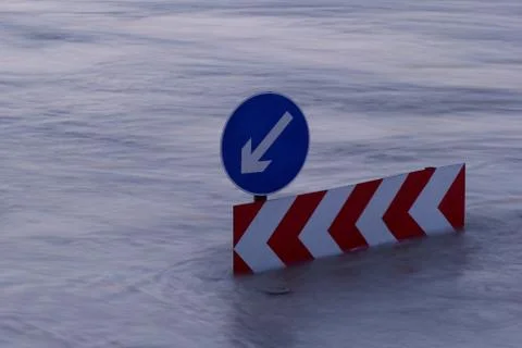 Direction boards on the flooding river Stock Photos