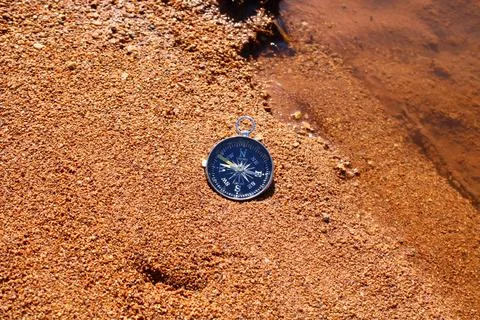Direction compass on the beach sand Stock Photos