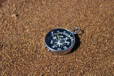 Direction compass on the beach sand Stock Photos