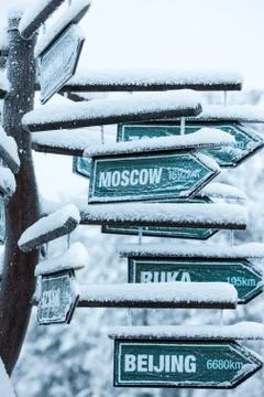 Direction to different places of the world indicated in a sign. Stock Photos