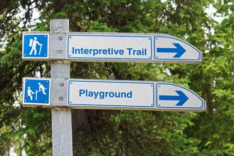 A direction sign for an interpretive trail and playground Stock Photos