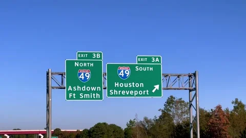 Direction signs on the highway to I-49 Shreveport and Houston - POV driving by - Stock Footage 221883201
