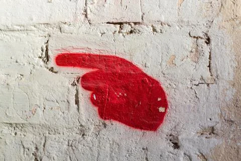 Directional pointer in a hand painted on old wall Stock Photos
