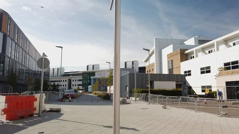 A directional post with white text on a purple background at Edinburgh Infirmary Stock Footage 115726285