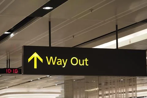 Directional sign indicates exit within busy terminal Stock Photos