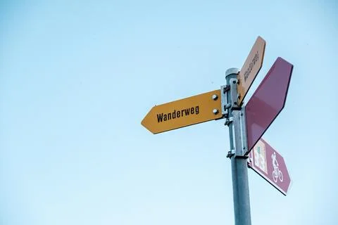 Directional signpost with multiple arrows indicating various paths Stock Photos