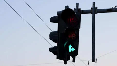 Directional traffic light changing from red to green signal Stock Footage 341954404