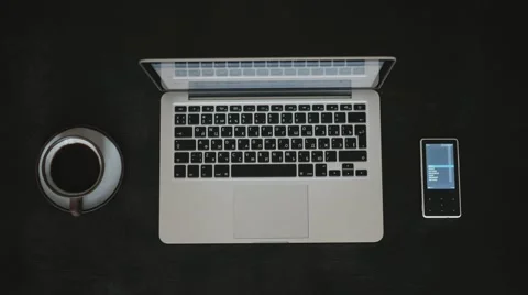 Directly Above Black Table a Man Working on a Laptop With a Cup of Coffee Video stock 68935621