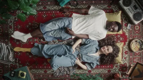 Directly Above of Couple Chatting and Smiling while Relaxing on Vintage Rug Vídeo Stock 339847641