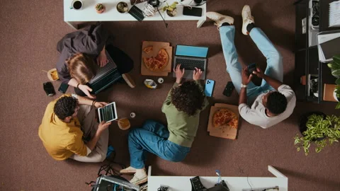 Directly Above of Multiethnic Young Team of Programmers Using Devices on Floor Stock-Footage 312542743