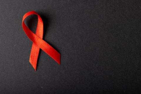 Directly above shot of aids awareness red ribbon isolated against black Stock Photos