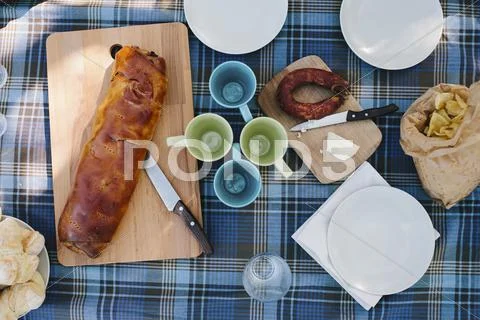 Directly Above Shot Of Empty Mugs With Bread On Table Outdoors