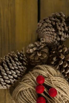 Directly above shot of pine cones with thread spool with push pin Stock Photos