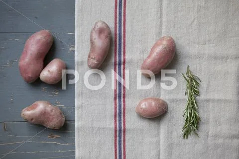 Directly Above Shot Of Potatoes With Rosemary On Table